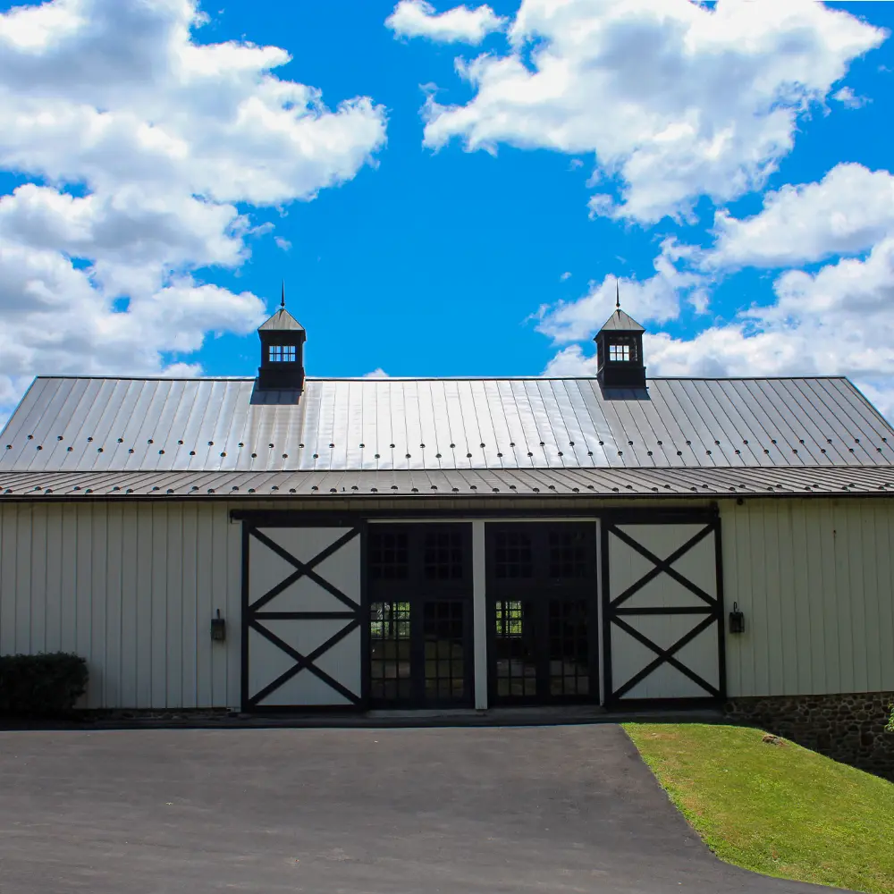 sunny, blue sky and a barn with doors open